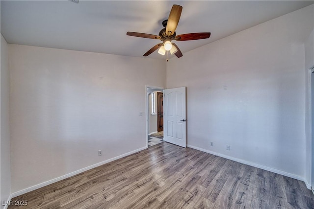 151 Hornet St, Pahrump, NV 89048 - empty room featuring wood finished floors, ceiling fan, baseboards, and vaulted ceiling