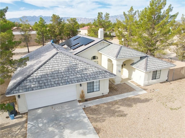 151 Hornet St, Pahrump, NV 89048 - view of front of house with an attached garage, stucco siding, concrete driveway, and a mountain view