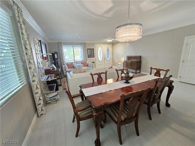 8303 Saddleback Ledge Ave, Las Vegas, NV 89147 - dining area with baseboards, light flooring, crown molding, and a chandelier