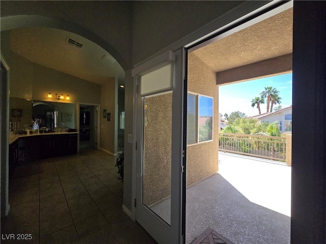 8303 Saddleback Ledge Ave, Las Vegas, NV 89147 - hallway featuring arched walkways and dark tile patterned flooring