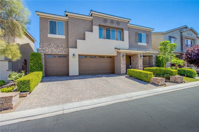 8303 Saddleback Ledge Ave, Las Vegas, NV 89147 - view of front facade with stone siding, stucco siding, a garage, and decorative driveway