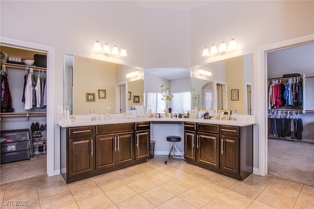 8303 Saddleback Ledge Ave, Las Vegas, NV 89147 - full bath featuring vanity, tile patterned flooring, a walk in closet, and a high ceiling