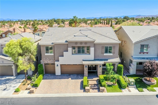 8303 Saddleback Ledge Ave, Las Vegas, NV 89147 - view of front facade featuring stucco siding, an attached garage, a residential view, driveway, and a tile roof