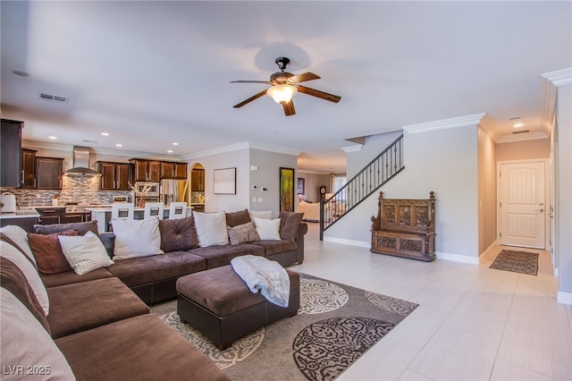 8303 Saddleback Ledge Ave, Las Vegas, NV 89147 - living room with a ceiling fan, crown molding, recessed lighting, arched walkways, and stairway