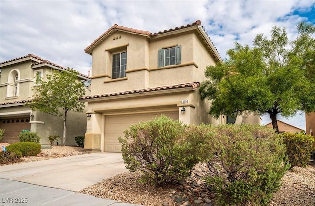 mediterranean / spanish home with an attached garage, a tile roof, driveway, and stucco siding