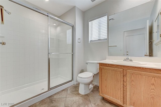 bathroom with tile patterned flooring, visible vents, toilet, vanity, and tiled shower
