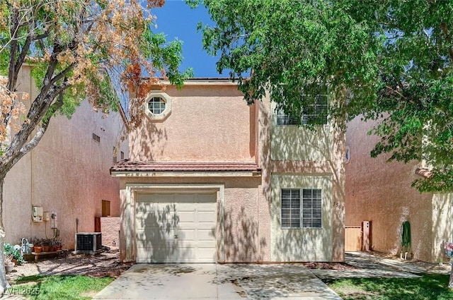 view of front of house featuring an attached garage, central AC unit, stucco siding, and driveway