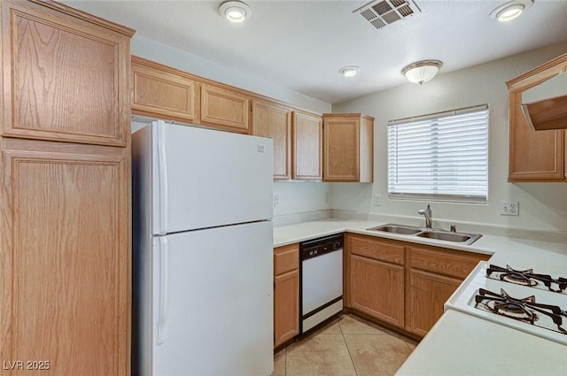 kitchen featuring a sink, white appliances, light tile patterned floors, light countertops, and visible vents