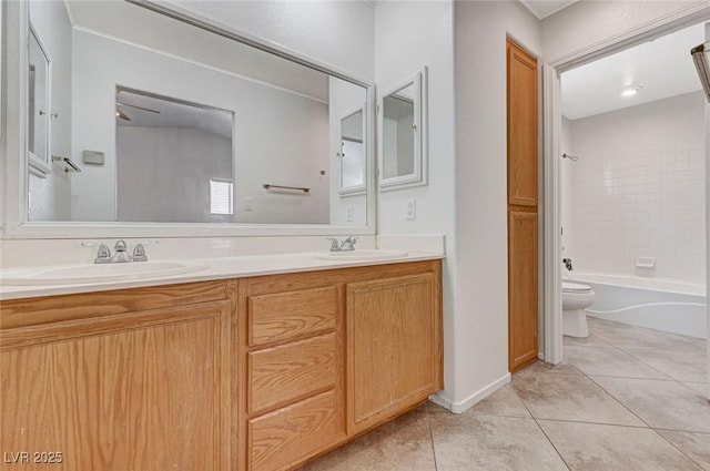 bathroom featuring toilet, tile patterned flooring, a sink, and double vanity