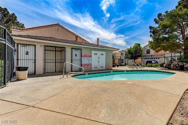 pool featuring a patio and fence