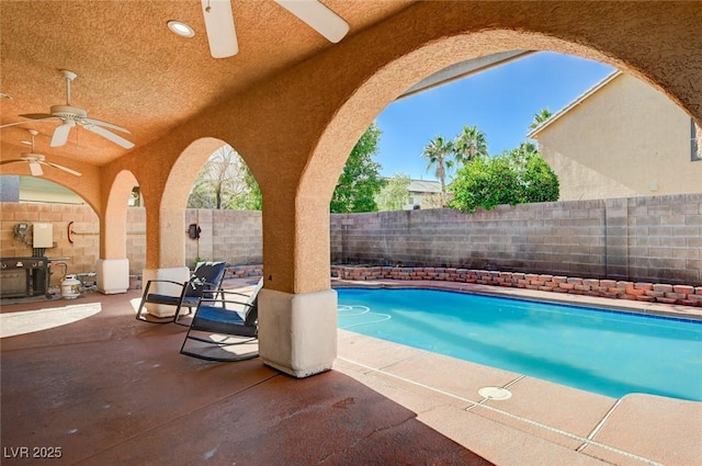 view of swimming pool featuring a ceiling fan, a fenced in pool, a patio, and a fenced backyard