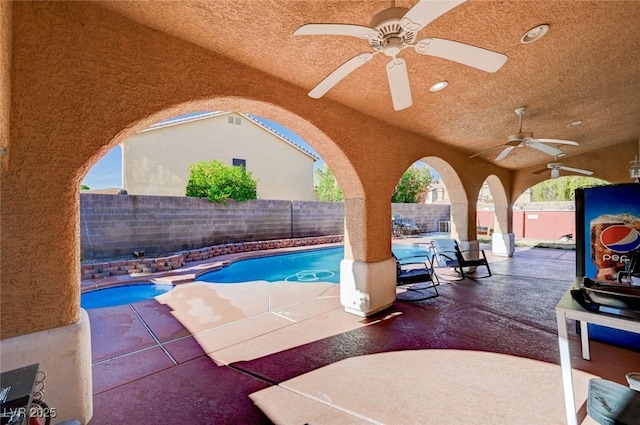 view of pool with a fenced backyard, a patio, and ceiling fan