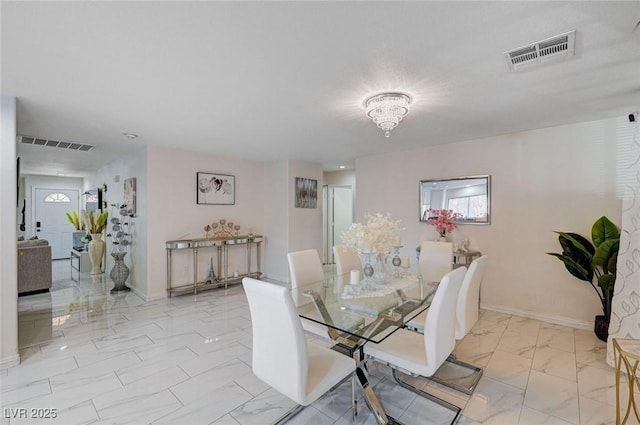 dining area with marble finish floor, baseboards, and visible vents