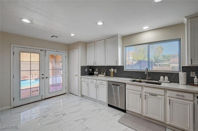 kitchen featuring french doors, a sink, visible vents, dishwasher, and light countertops