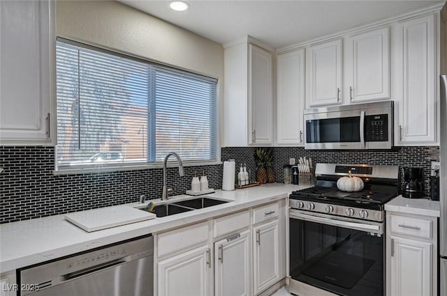 kitchen with white cabinets, stainless steel appliances, and a sink