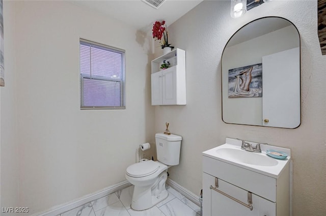 half bath with marble finish floor, baseboards, toilet, and vanity