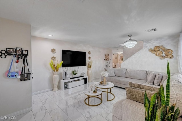 living area featuring visible vents, marble finish floor, and baseboards