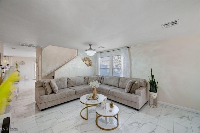 living room with visible vents, marble finish floor, and baseboards