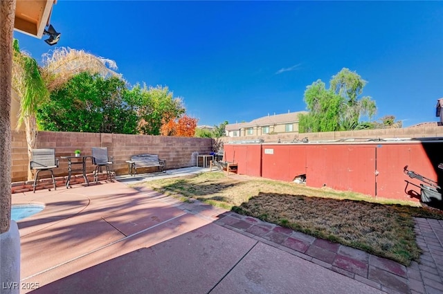 view of yard featuring fence and a patio