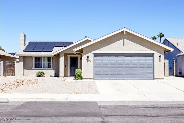 6198 Pinewood Ave, Las Vegas, NV 89103 - ranch-style house featuring roof mounted solar panels, driveway, an attached garage, and stucco siding