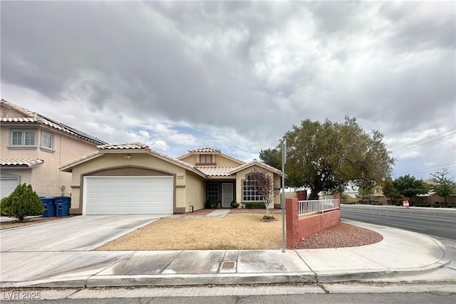 4484 Warbonnet Way, Las Vegas, NV 89147 - view of front of house with an attached garage, driveway, stucco siding, fence private yard, and a tiled roof