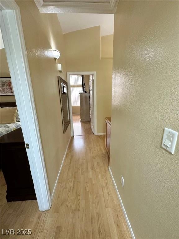 4484 Warbonnet Way, Las Vegas, NV 89147 - hallway featuring ornamental molding, light wood-style flooring, a textured wall, and baseboards