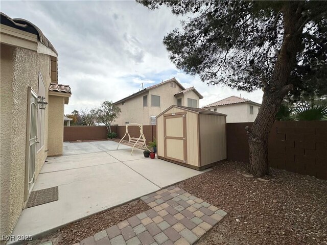 4484 Warbonnet Way, Las Vegas, NV 89147 - view of patio featuring a storage shed, an outdoor structure, and a fenced backyard