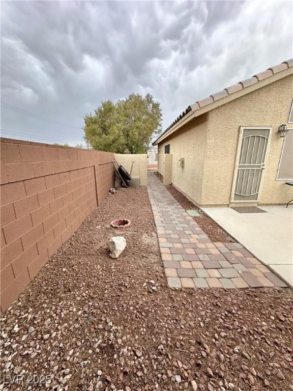 4484 Warbonnet Way, Las Vegas, NV 89147 - view of yard featuring a patio area and fence
