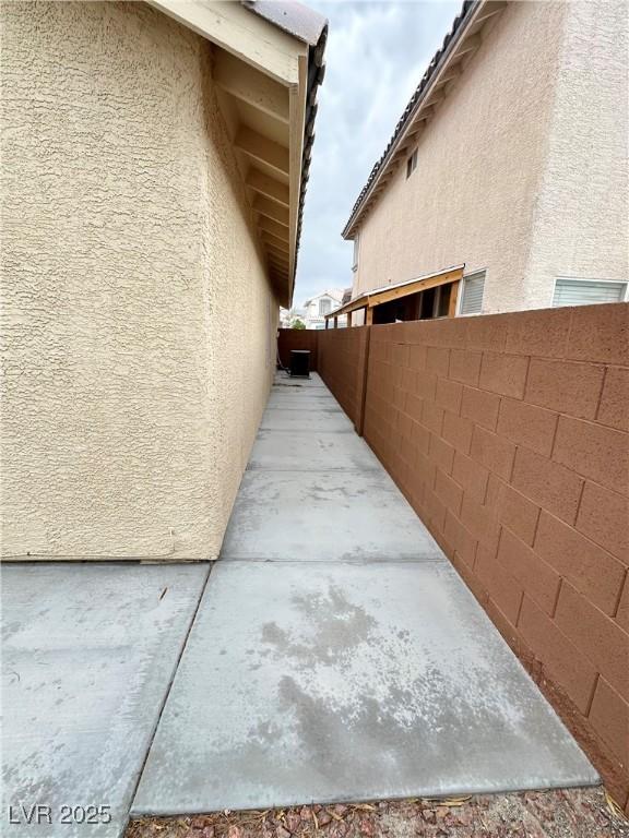 4484 Warbonnet Way, Las Vegas, NV 89147 - view of side of home with fence and stucco siding