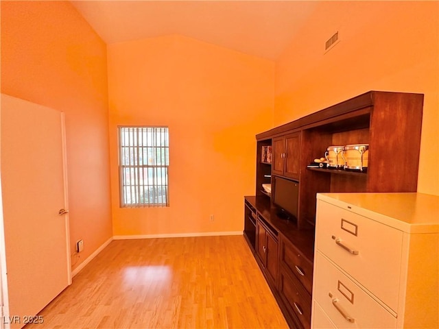 4484 Warbonnet Way, Las Vegas, NV 89147 - living area with baseboards, light wood-style floors, visible vents, and high vaulted ceiling
