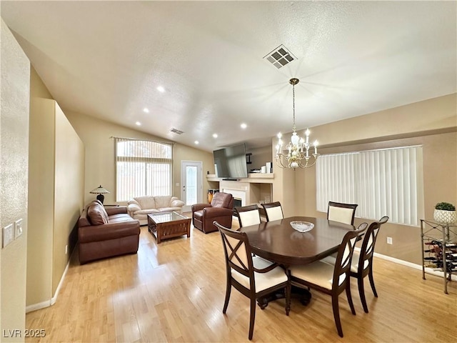 4484 Warbonnet Way, Las Vegas, NV 89147 - dining space featuring vaulted ceiling, an inviting chandelier, visible vents, and light wood-style floors