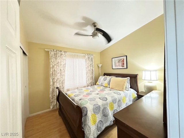 4484 Warbonnet Way, Las Vegas, NV 89147 - bedroom with lofted ceiling, a closet, baseboards, ceiling fan, and wood finished floors