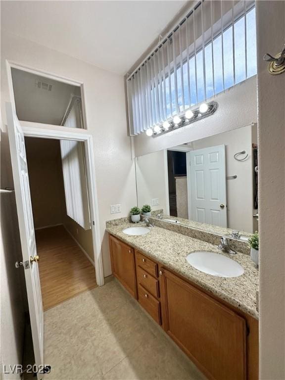 4484 Warbonnet Way, Las Vegas, NV 89147 - bathroom featuring wood finished floors, visible vents, a sink, and double vanity