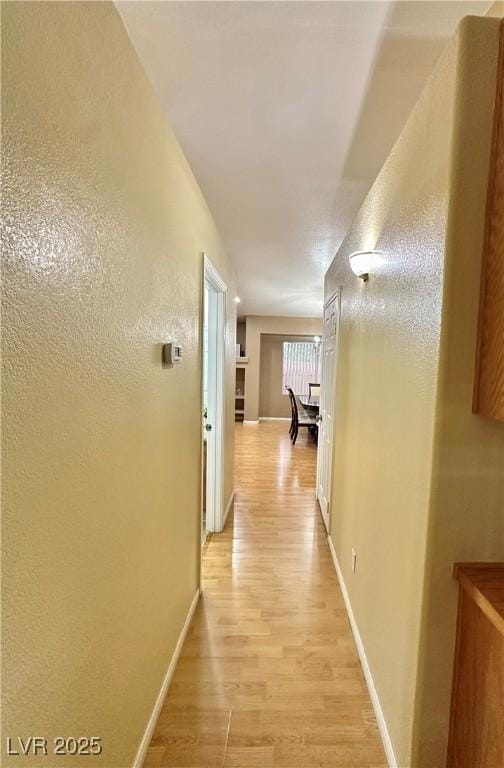 4484 Warbonnet Way, Las Vegas, NV 89147 - corridor featuring baseboards and light wood-type flooring
