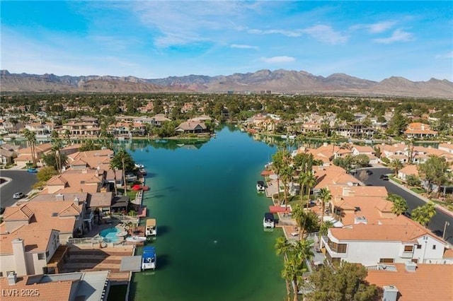 birds eye view of property featuring a water and mountain view and a residential view