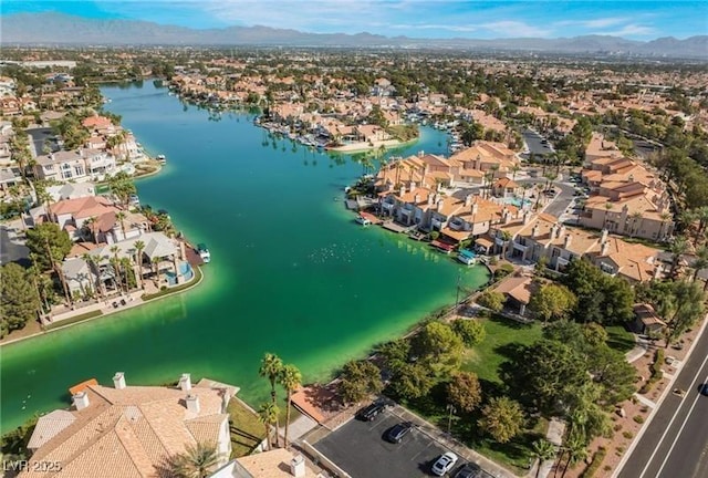 aerial view with a water and mountain view and a residential view