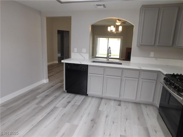 kitchen featuring visible vents, a sink, arched walkways, gas stove, and black dishwasher
