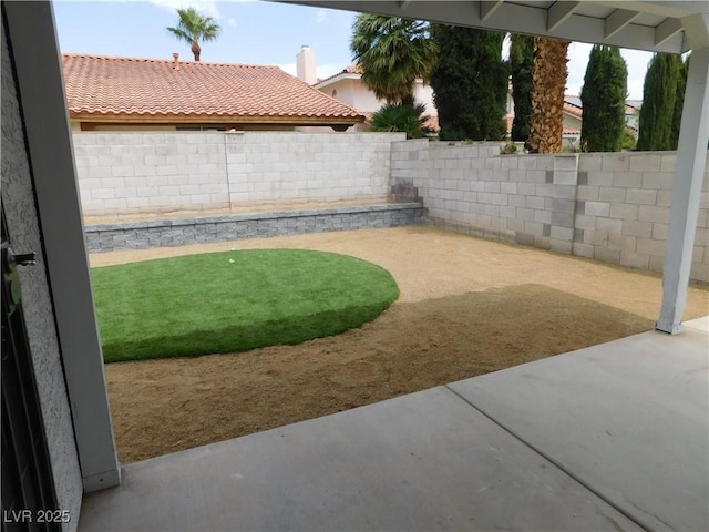 view of yard with a fenced backyard and a patio