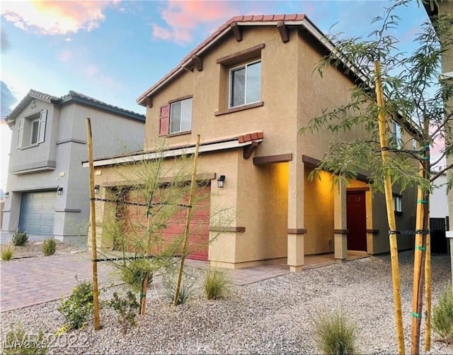 7892 W Shelbourne Ave, Las Vegas, NV 89113 - view of front of property featuring stucco siding, a tile roof, and a garage