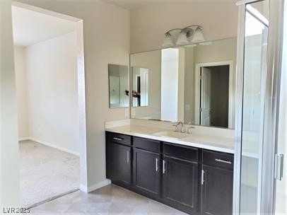 bathroom featuring baseboards, tile patterned flooring, and vanity