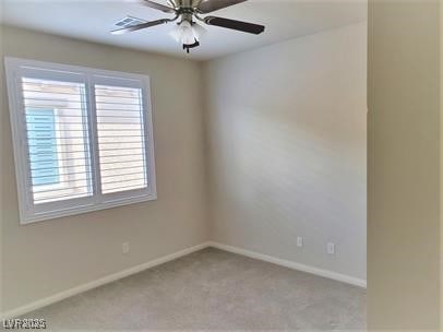 empty room featuring light carpet, baseboards, and ceiling fan