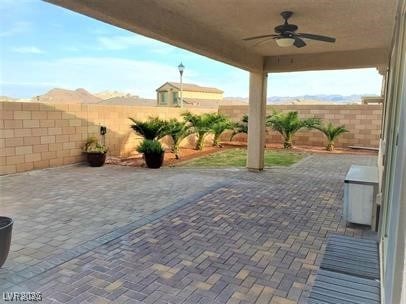 view of patio featuring a fenced backyard and a ceiling fan