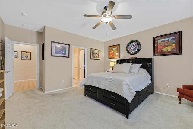 bedroom featuring visible vents, a ceiling fan, baseboards, and light colored carpet