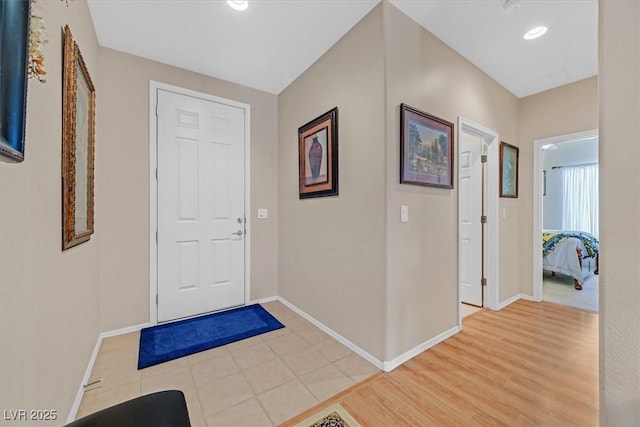 foyer featuring light wood-type flooring and baseboards
