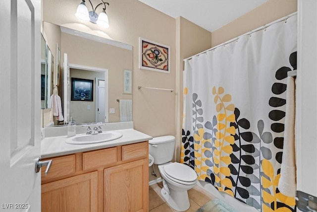bathroom with curtained shower, vanity, tile patterned flooring, and toilet