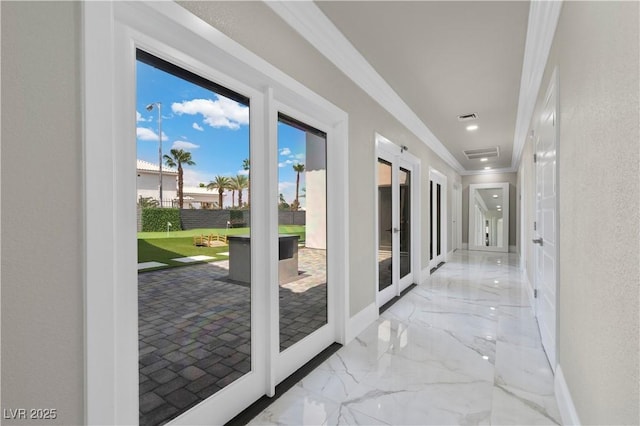 hallway featuring visible vents, baseboards, ornamental molding, and french doors