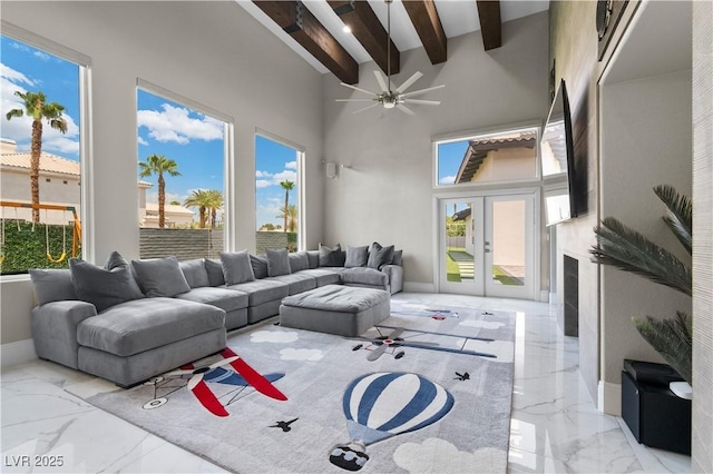 2715 Twin Palms Cir, Las Vegas, NV 89117 - living area with marble tiled flooring, beamed ceiling, a high ceiling, ceiling fan, and healthy amount of natural light