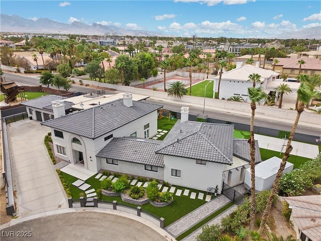 birds eye view of property featuring a mountain view and a residential view