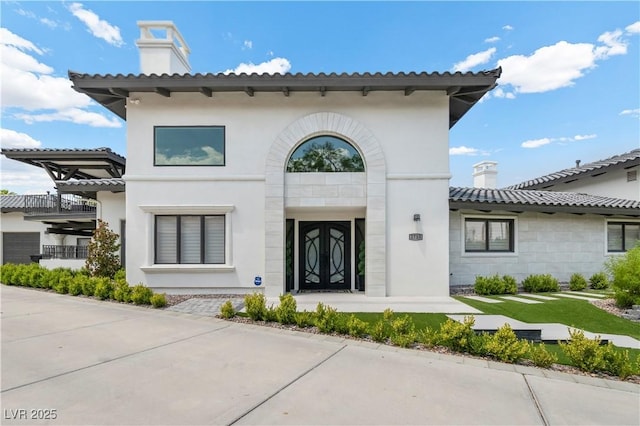 2715 Twin Palms Cir, Las Vegas, NV 89117 - view of front of home featuring a chimney, stucco siding, and stone siding