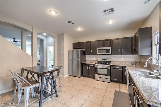 5593 Gold Mint Ln, Las Vegas, NV 89122 - kitchen with arched walkways, visible vents, a sink, and appliances with stainless steel finishes